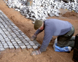 Laying grey natural setts .