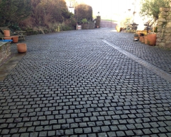 A large driveway with 10 10 10 grey setts